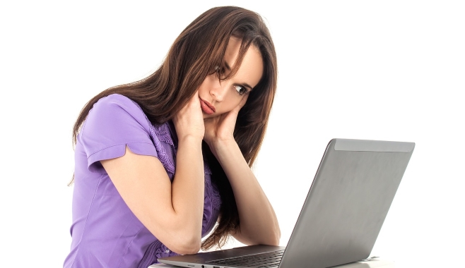 Concerned Woman Reading From Laptop